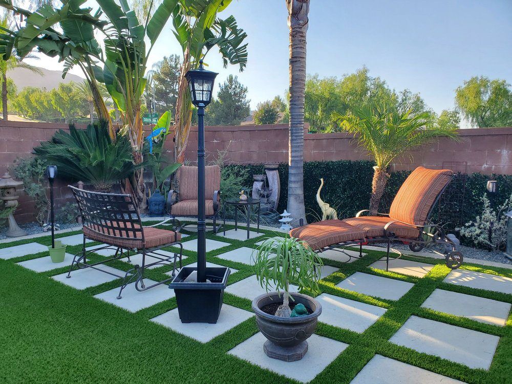 Backyard patio with checkerboard pavers and turf